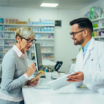 young pharmacist assessing the elderly woman